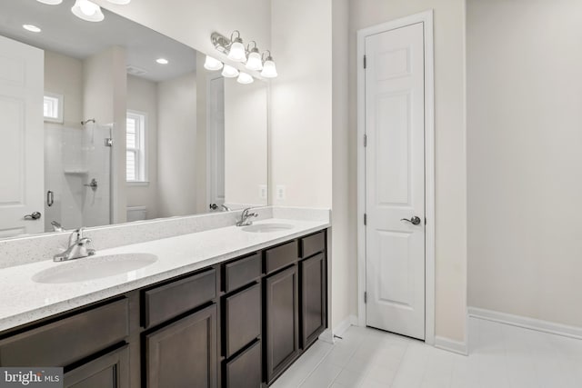 bathroom featuring vanity, toilet, and a shower with door