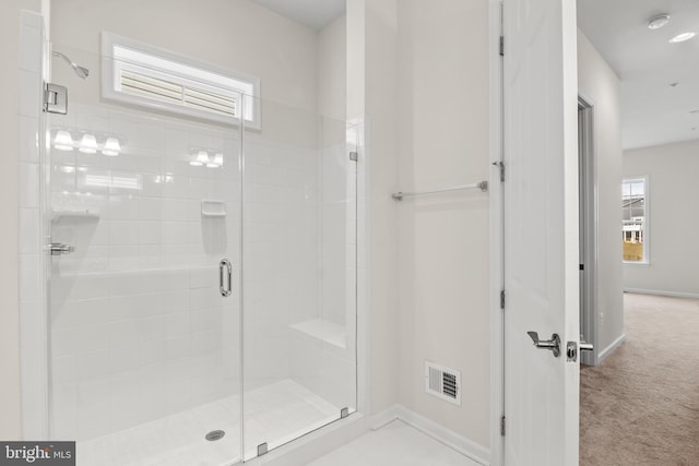 bathroom featuring plenty of natural light and an enclosed shower