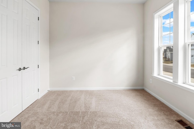 unfurnished bedroom featuring a closet and carpet flooring