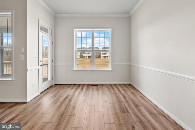 interior space featuring light wood-type flooring and crown molding