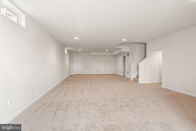 unfurnished living room featuring light colored carpet