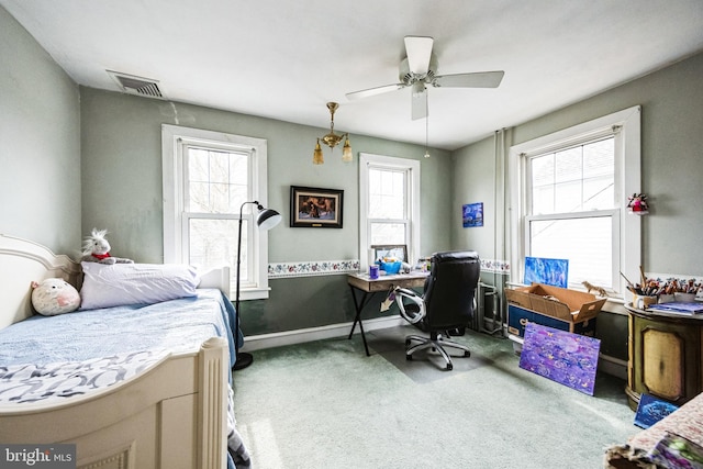 carpeted bedroom with baseboards, visible vents, and a ceiling fan