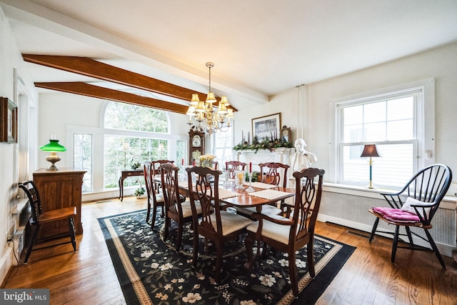 dining space with vaulted ceiling with beams, wood finished floors, and a notable chandelier