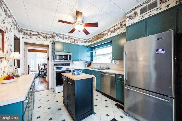 kitchen with wood counters, visible vents, appliances with stainless steel finishes, open shelves, and wallpapered walls