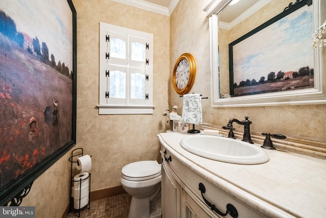 bathroom featuring baseboards, crown molding, vanity, and toilet