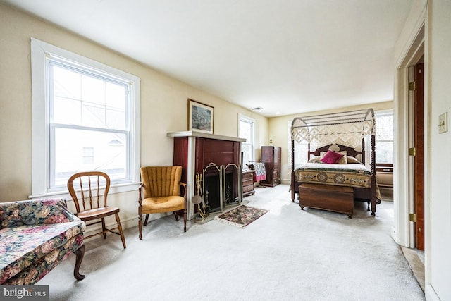 bedroom featuring multiple windows, visible vents, and light colored carpet