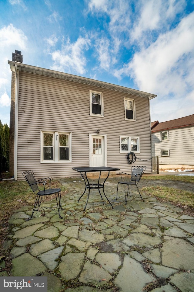 back of house with a patio