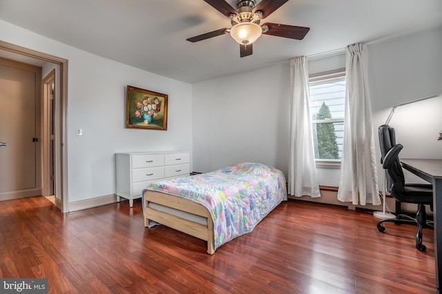 bedroom with ceiling fan and dark hardwood / wood-style flooring