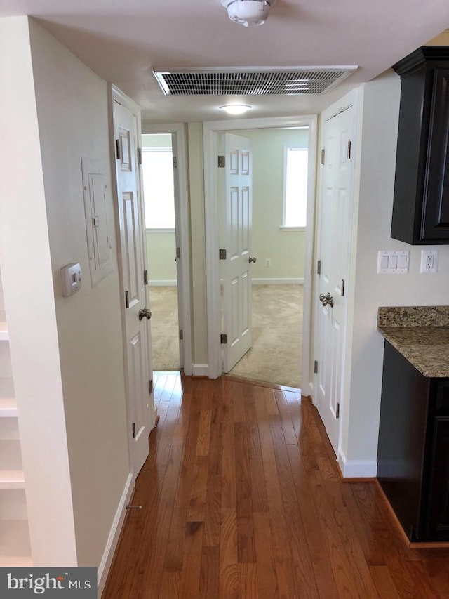 hallway with dark hardwood / wood-style flooring