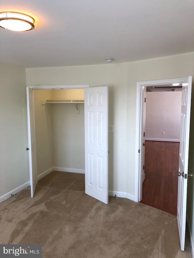 unfurnished bedroom with carpet and a closet