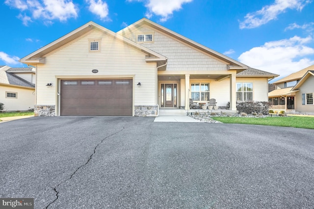 view of front of house with a porch and a garage