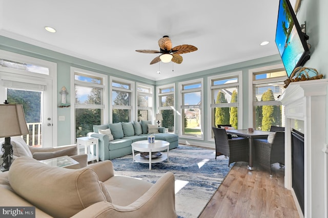 sunroom with a wealth of natural light and ceiling fan