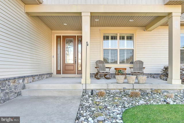 view of exterior entry with a porch