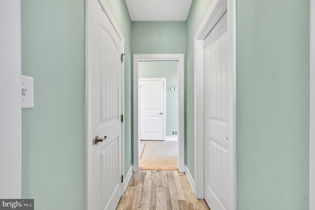 hall with light hardwood / wood-style flooring