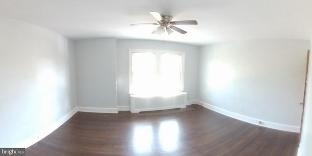 empty room with ceiling fan and dark hardwood / wood-style floors