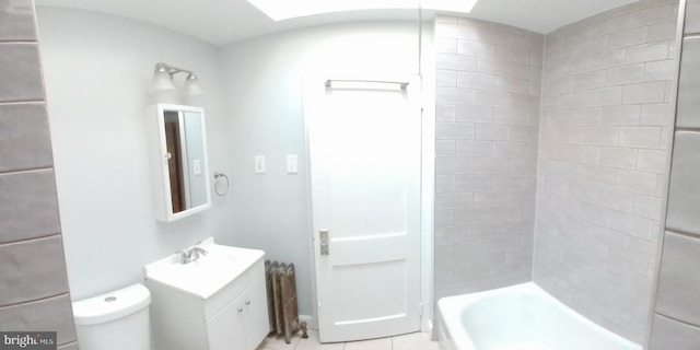 full bathroom featuring tile patterned floors, toilet, vanity, and tiled shower / bath