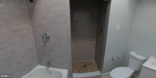 full bathroom with vanity, toilet, and tiled shower / bath