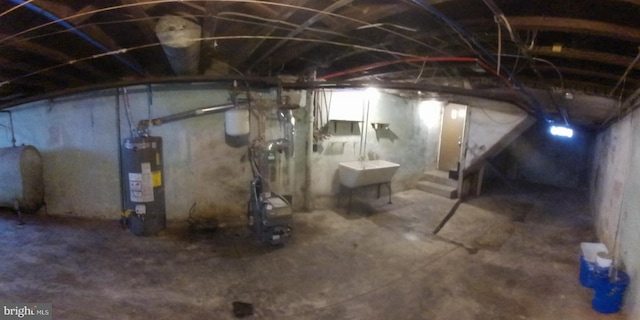 basement with water heater and sink