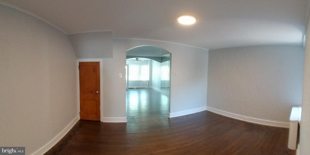 unfurnished room with dark wood-type flooring