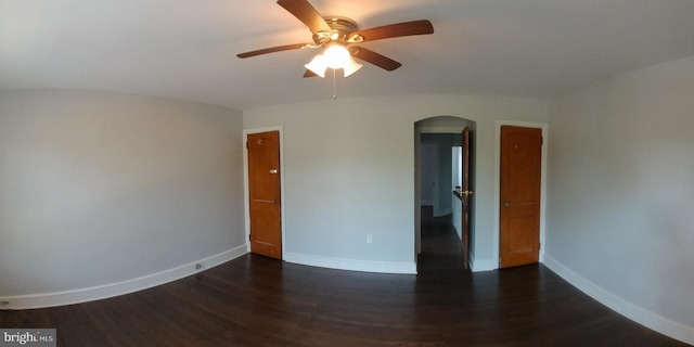 empty room featuring dark hardwood / wood-style flooring and ceiling fan