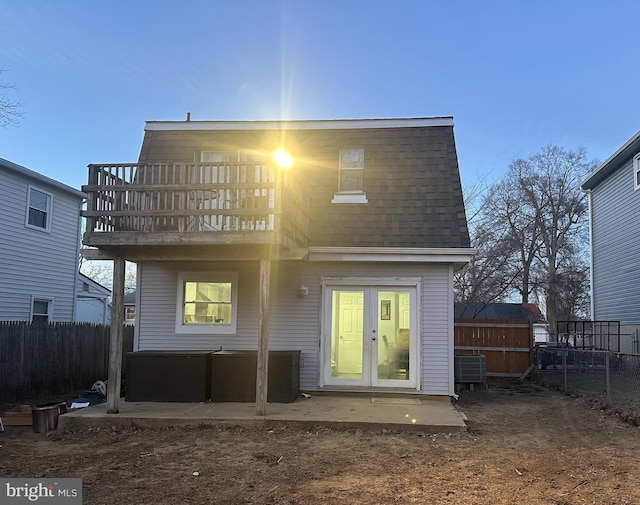 rear view of house with french doors, a patio area, fence, a balcony, and a jacuzzi