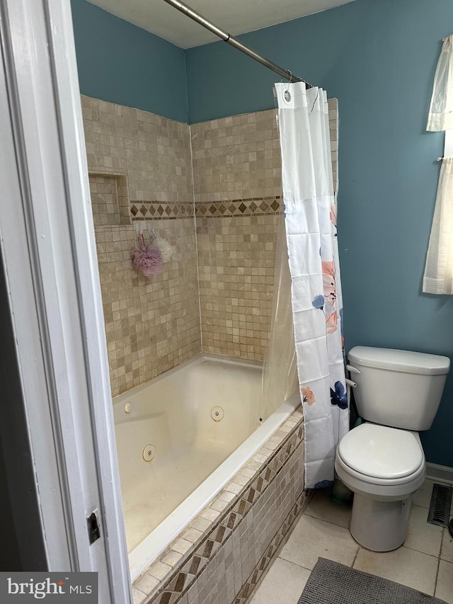 full bath with a combined bath / shower with jetted tub, visible vents, toilet, and tile patterned floors