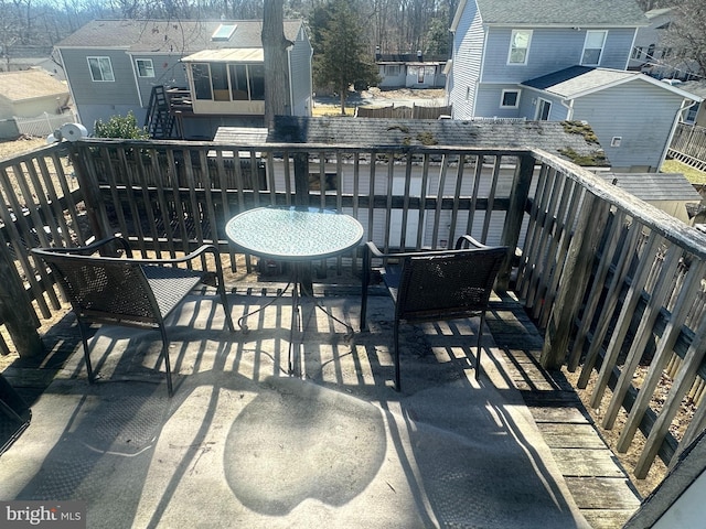 balcony with outdoor dining space and a residential view