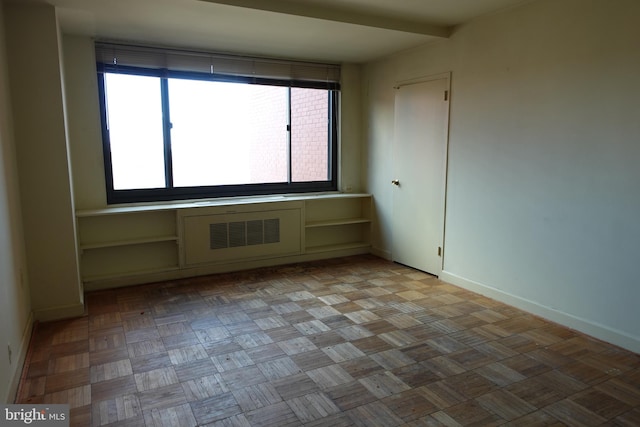 empty room featuring baseboards