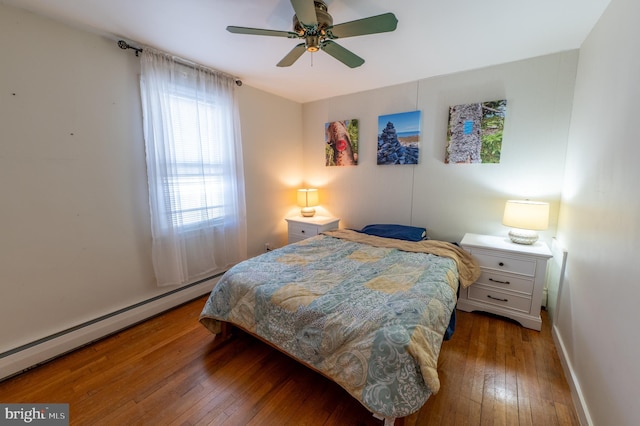 bedroom with ceiling fan, dark wood-style flooring, a baseboard radiator, and baseboards