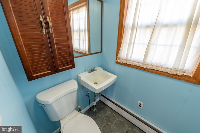 bathroom with a baseboard radiator, a sink, and toilet