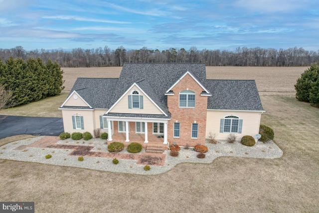 view of front of property featuring covered porch and a front yard