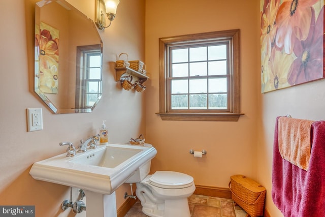 bathroom with toilet and plenty of natural light