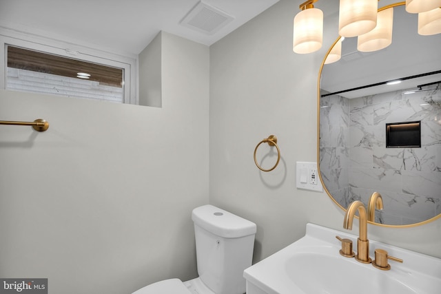 bathroom featuring visible vents, vanity, and toilet