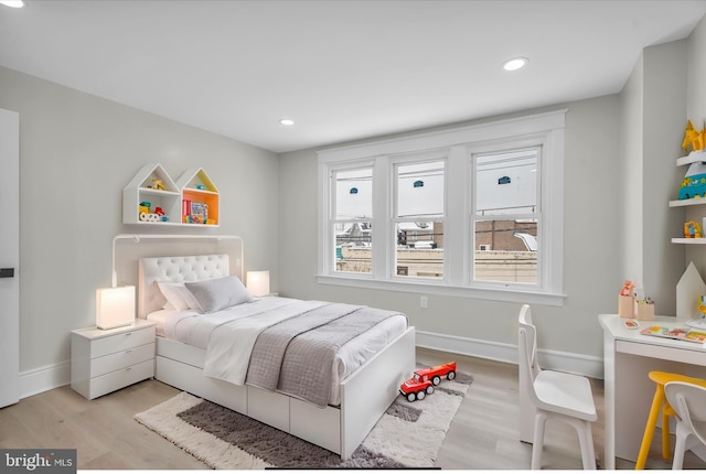 bedroom with light wood finished floors, recessed lighting, and baseboards