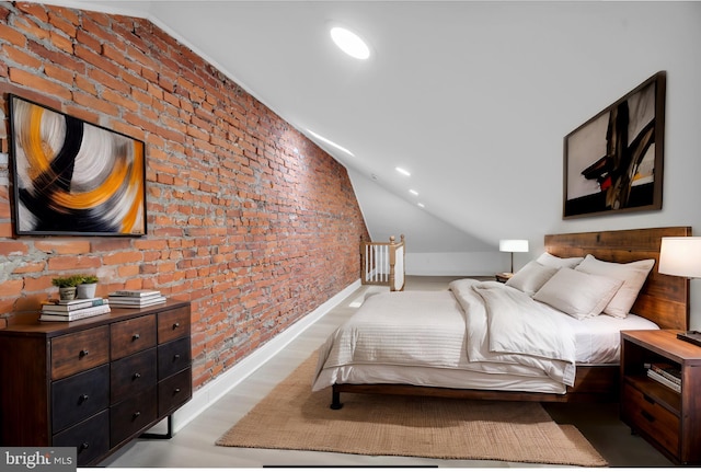 bedroom with light wood-style floors, recessed lighting, vaulted ceiling, and brick wall