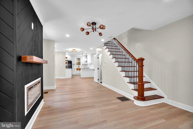 entrance foyer featuring light wood-style flooring, recessed lighting, visible vents, baseboards, and stairs