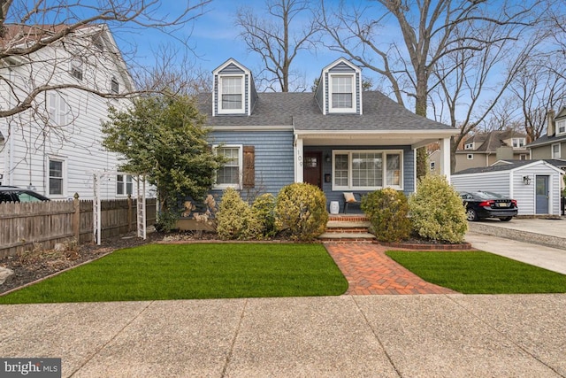 cape cod-style house featuring a porch and a front yard