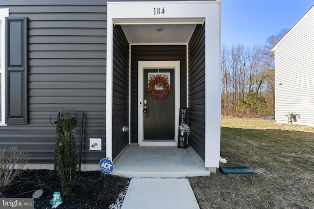 entrance to property with a yard