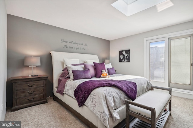 bedroom with light carpet and a skylight