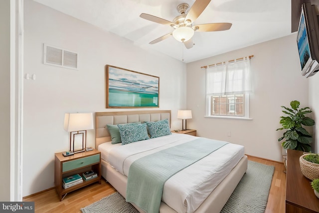 bedroom with light wood-type flooring and ceiling fan