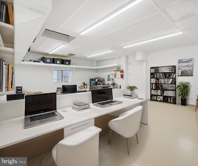 office with concrete floors and built in desk