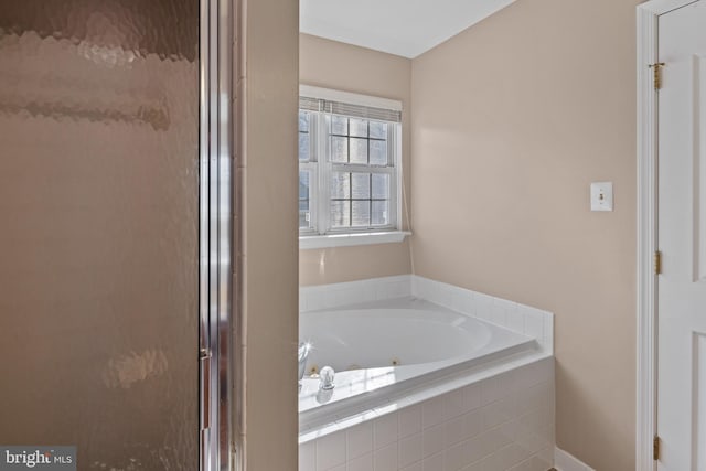 full bathroom featuring a garden tub and a shower stall