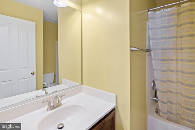 full bathroom featuring shower / tub combo, vanity, and toilet