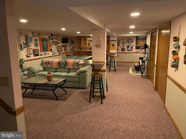 carpeted living room with a wainscoted wall, wallpapered walls, and recessed lighting