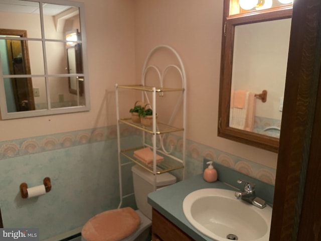 bathroom featuring vanity and toilet