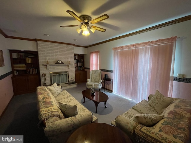 living room featuring carpet floors, ceiling fan, a fireplace, and crown molding