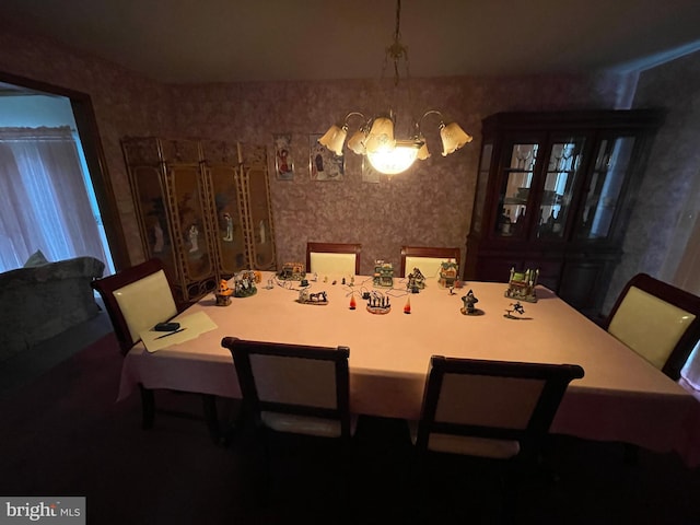 dining room featuring wallpapered walls and a chandelier