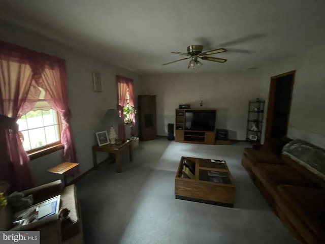 living area featuring concrete floors and ceiling fan