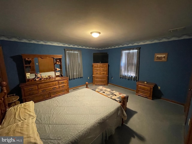 carpeted bedroom with visible vents and baseboards