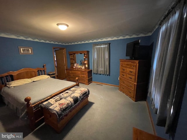 bedroom with light carpet and baseboards